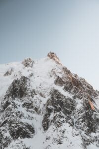 A man riding skis on top of a snow covered mountain