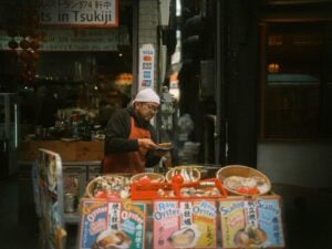A man prepares food at a tsukiji market stall.