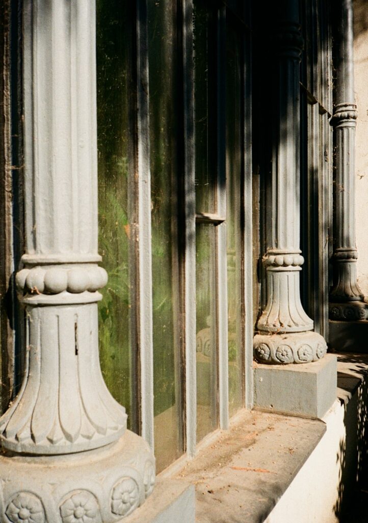 Stone columns frame a window's glass panes.