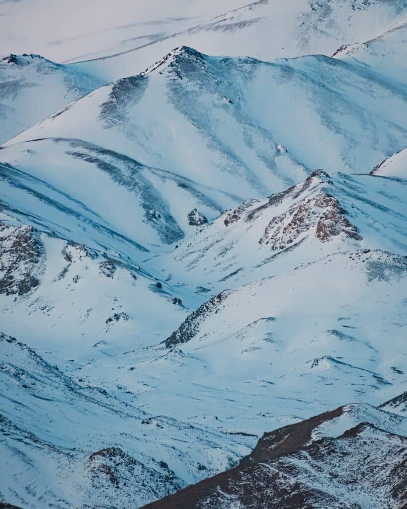 Snow-covered mountains against a blue sky.