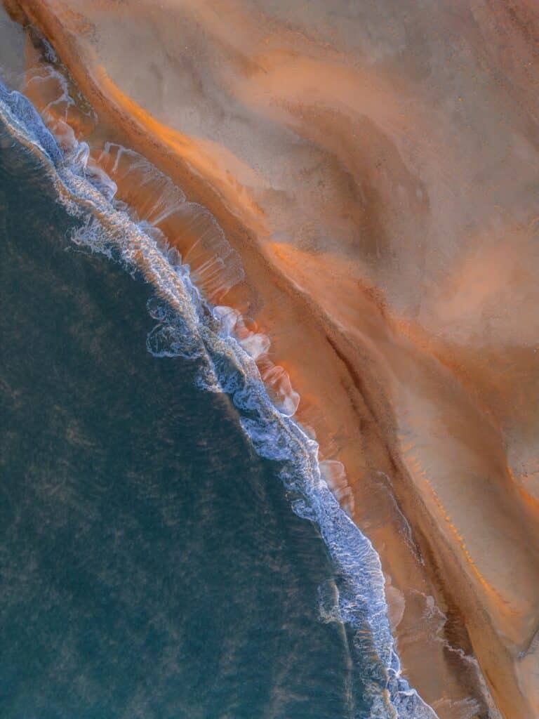 Waves crash on a beautiful, sandy beach.