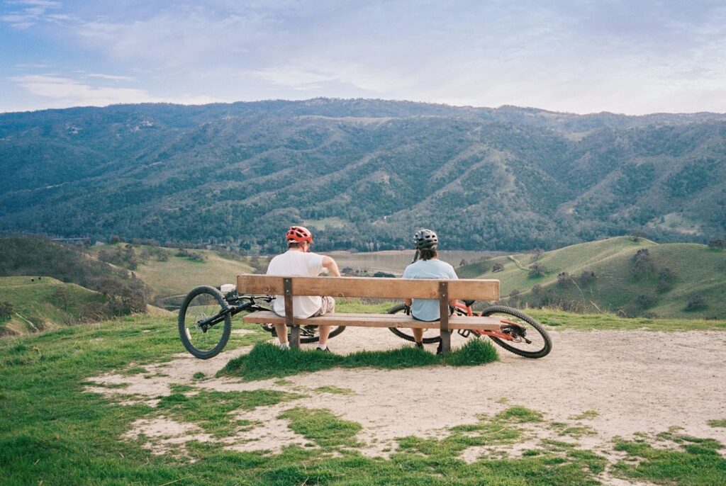Two cyclists enjoy a scenic overlook.