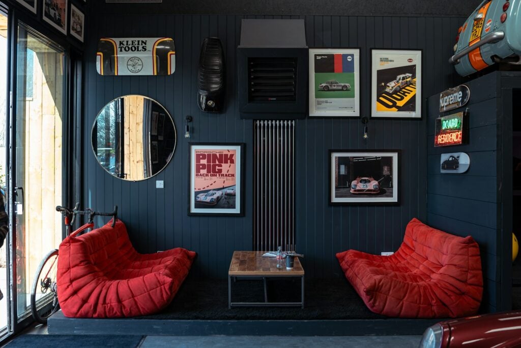 Cozy room with two red chairs and car memorabilia.
