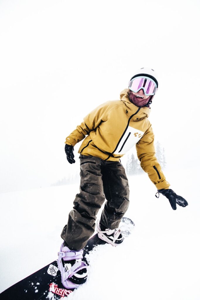 Snowboarder enjoying a snowy day on the slopes.