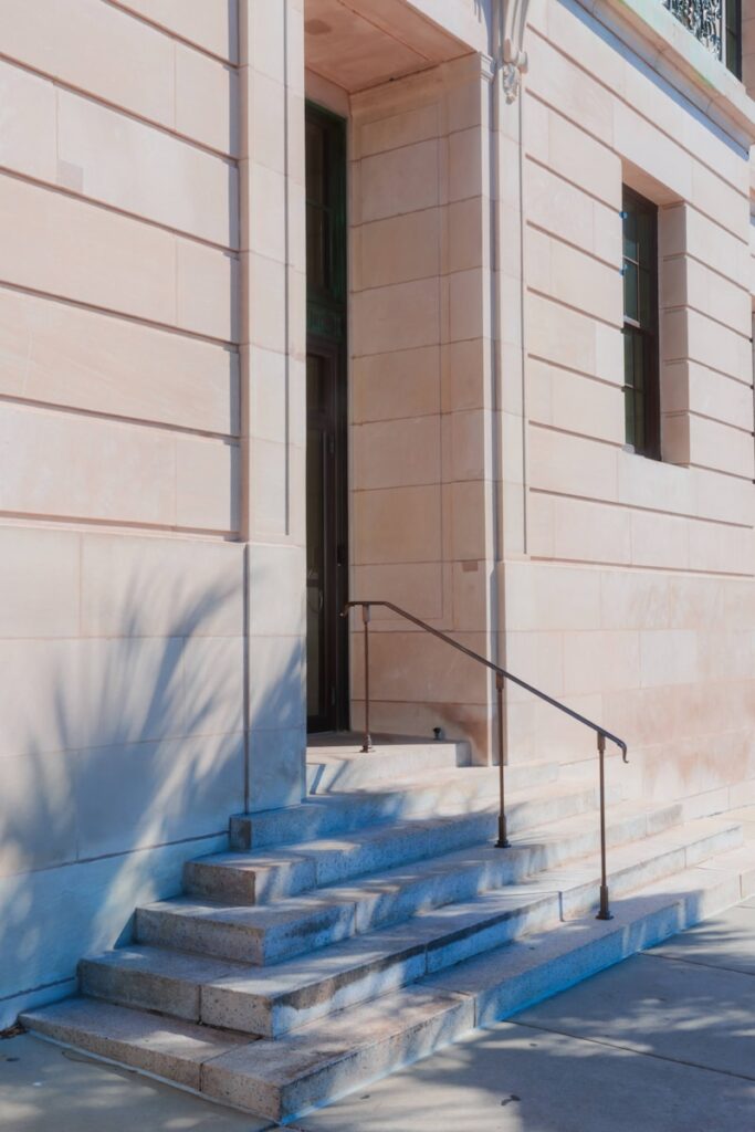 Stone steps lead to a building's entrance.