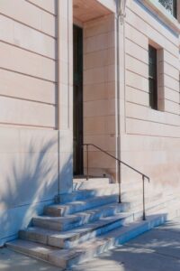 Stone steps lead to a building's entrance.
