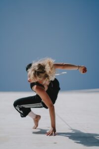 A woman performs a breakdancing move.