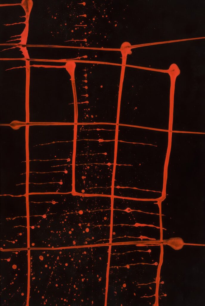 Red paint drips over a black background.