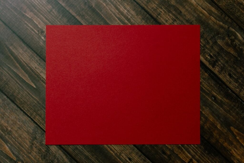 red paper on brown and gray plaid textile