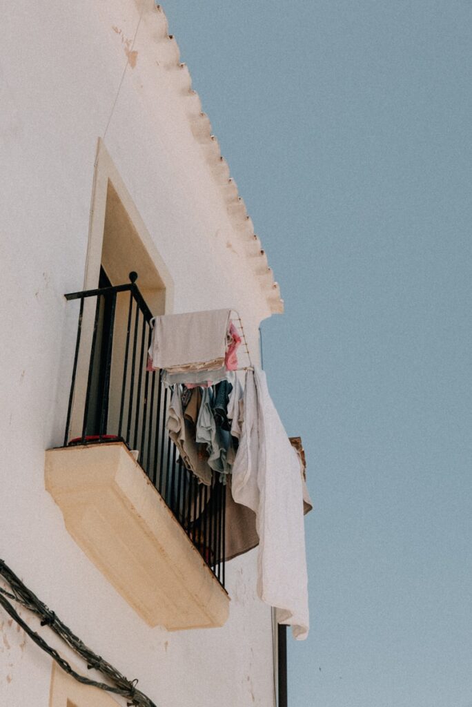 A balcony with clothes hanging out of it