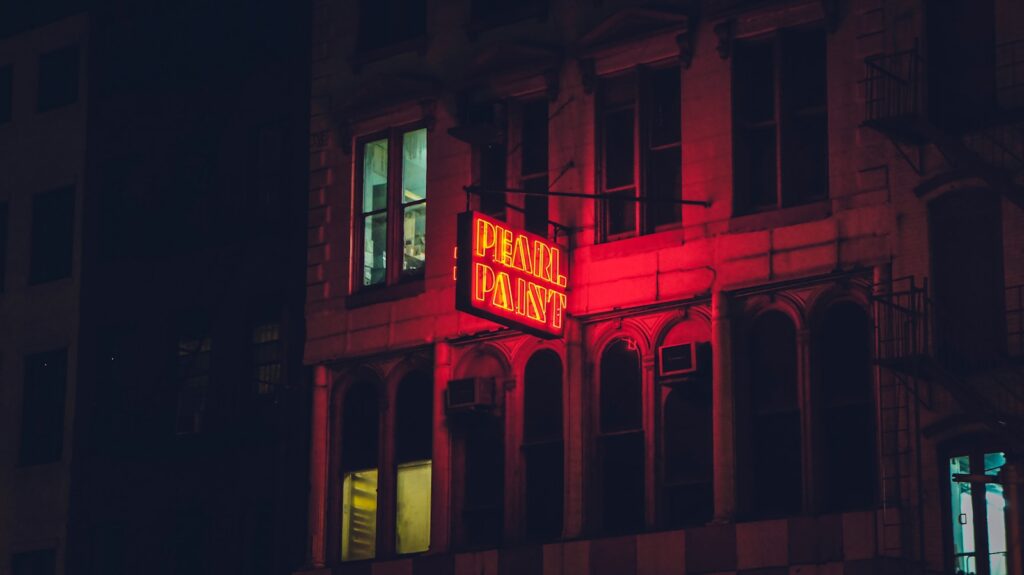a building with a neon sign on it's side