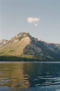 A mountain is in the distance with a body of water in front of it
