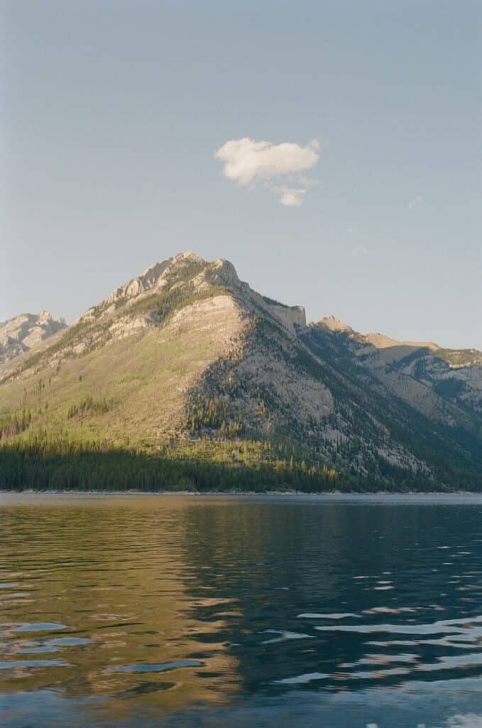 A mountain is in the distance with a body of water in front of it