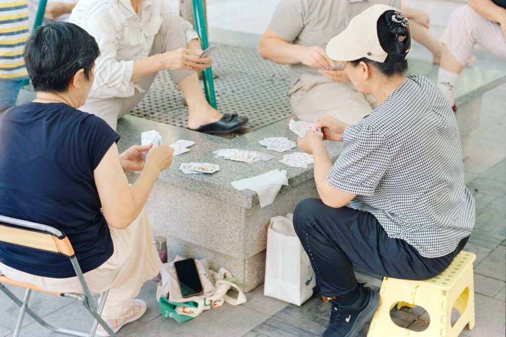 People are playing cards outdoors.