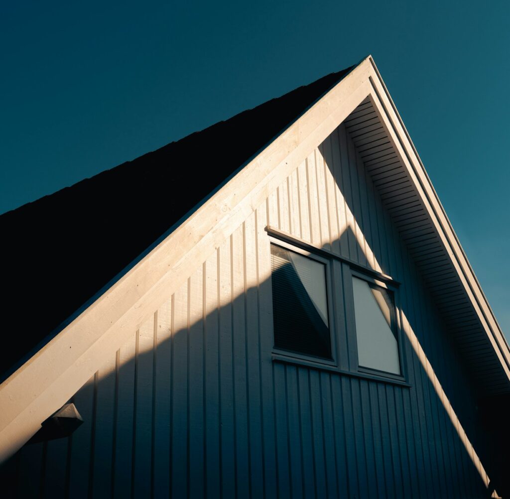 The gable roof of a house basks in sunlight.