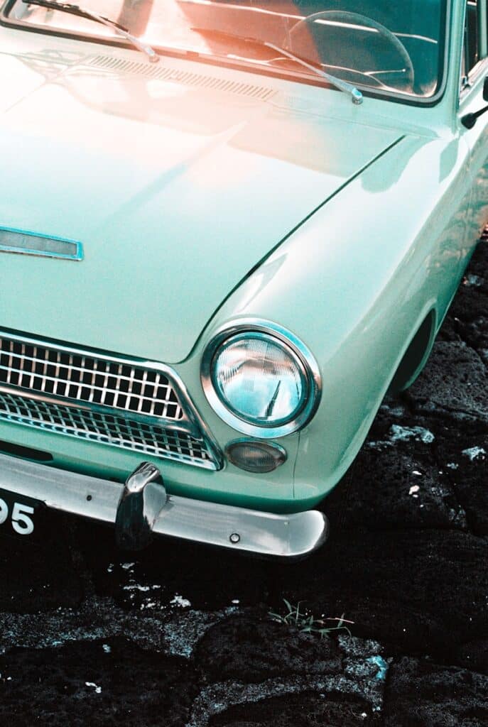 Vintage car's front is shown in a close-up.