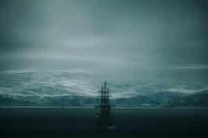 A ship sails in a cold, icy seascape.