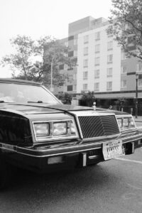 A black limousine parked on a city street.