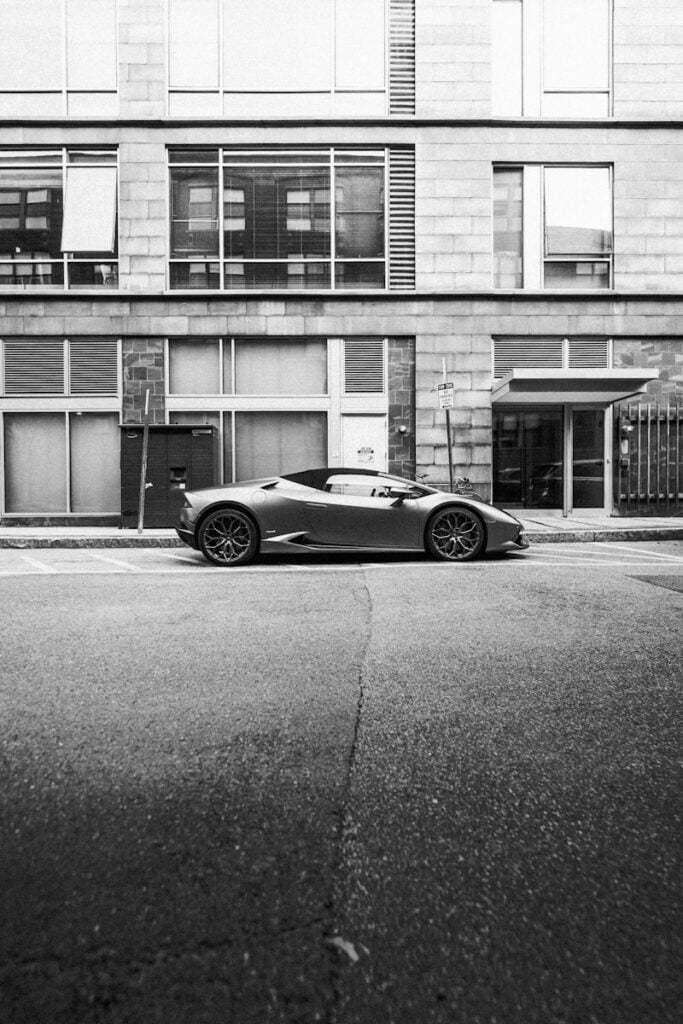 A sleek sports car parked in front of a building.